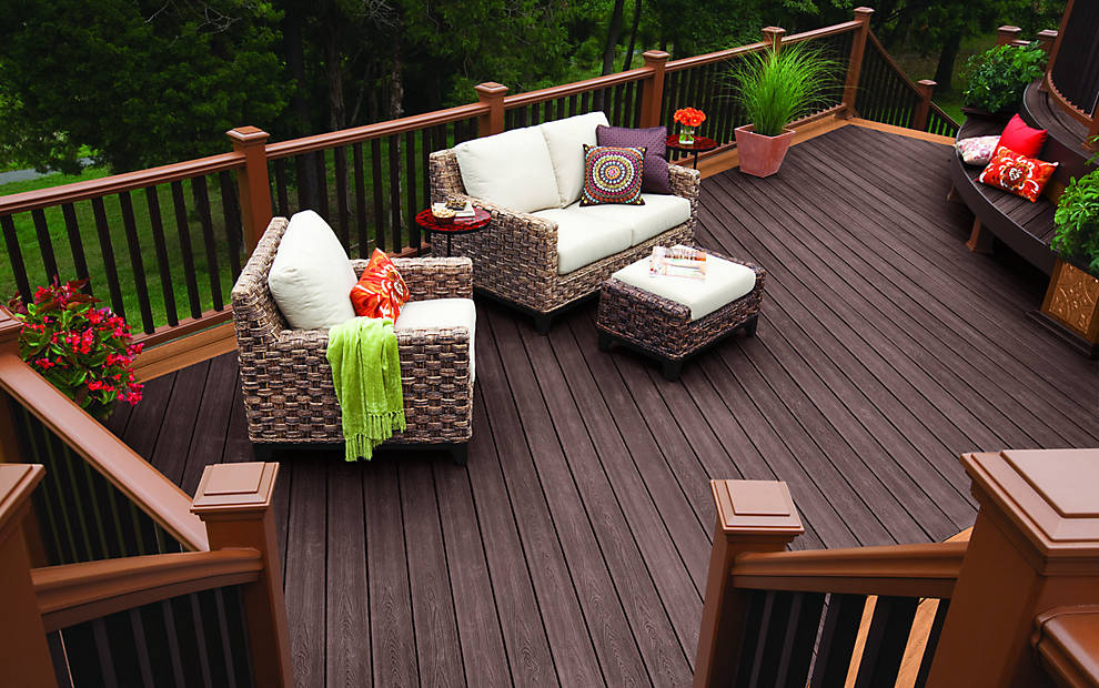 A durable Trex composite deck with a dark stain and lighter railing, built by Epic Deck Builders